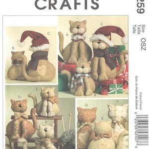 May include: A McCall's Crafts pattern featuring various cat-shaped plushies. The cats are in different poses and styles, some wearing scarves and Santa hats. The pattern includes the designer's name, Cynthia Rose.