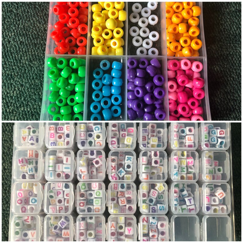 May include: Assortment of colorful plastic beads in small containers. The beads are in various colors, including red, yellow, green, blue, purple, and pink. The containers are labeled with letters of the alphabet.
