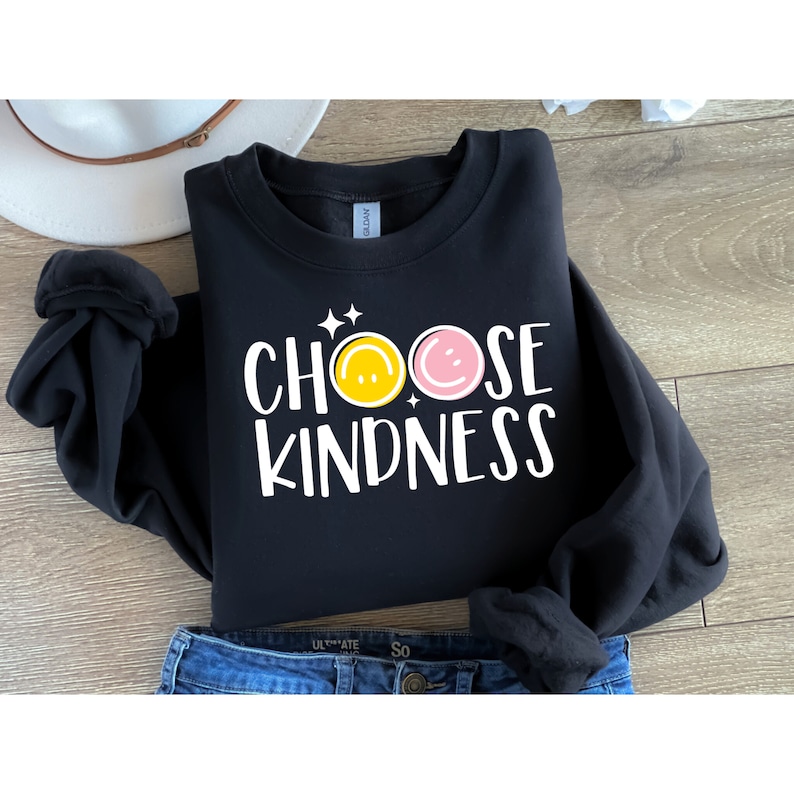 May include: Black sweatshirt with the text "CHOOSE KINDNESS" in white with two yellow and pink smiley faces.