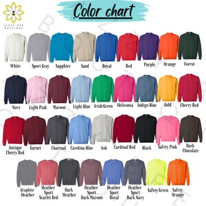 May include: Color chart showing 24 different sweatshirt colors. The colors are arranged in four rows of six colors each. The colors are: White, Sport Gray, Sapphire, Sand, Royal, Red, Purple, Orange, Forest, Navy, Light Pink, Maroon, Light Blue, Irish Green, Heliconia, Indigo Blue, Gold, Cherry Red, Antique Cherry Red, Garnet, Charcoal, Carolina Blue, Ash, Cardinal Red, Black, Safety Pink, Dark Chocolate, Graphite Heather, Heather Sport Scarlet Red, Dark Heather, Heather Sport Dark Maroon, Heather Sport Royal, Heather Sport Dark Navy, Safety Green, Safety Orange.