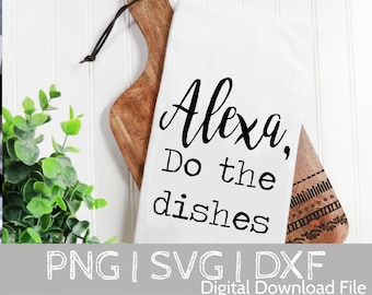 May include: A white kitchen towel with black text that reads "Alexa, Do the dishes". The towel is hanging on a wooden cutting board with a decorative pattern.