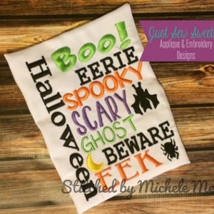 May include: White t-shirt with colourful embroidered Halloween words, including "Boo!", "Eerie", "Spooky", "Scary", "Ghost", "Beware", and "EEK". The text "Just Sew Sweetly Applique & Embroidery Designs" and "Stitched by Michele Meewes" are also embroidered on the shirt.