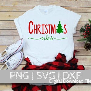 May include: White t-shirt with red text that says "Christmas vibes" and a green Christmas tree graphic.
