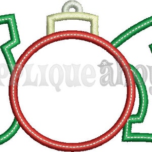 May include: A Christmas ornament design with the word "JOY" in green, stitched lettering. The "O" is a red circle, and the ornament's top is beige. The design is likely for embroidery or applique.