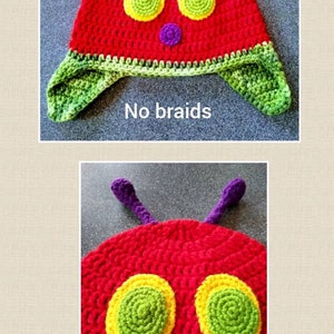 May include: A red crocheted hat with green and yellow eyes, a purple nose, and green ear flaps. The hat is shaped like a caterpillar and has the text "No braids" written below it.
