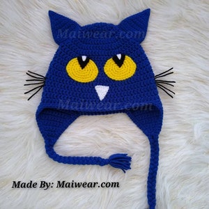 May include: Blue crocheted cat hat with yellow eyes and white nose. The hat has long blue braids with tassels at the end. Made By: Maiwear.com