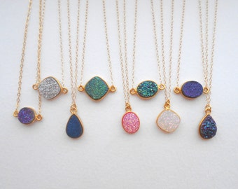 May include: Eight gold necklaces with different colored and shaped agate gemstone pendants. The pendants include a teardrop, oval, square, and round shapes. The colors include blue, green, pink, white, and silver.