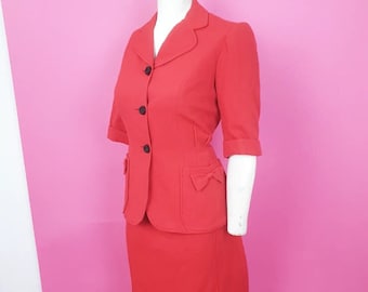 Stunning 1940s reddy orange wool skirt suit has shorter sleeves lovely bow detail to pockets a fab colour and tailoring