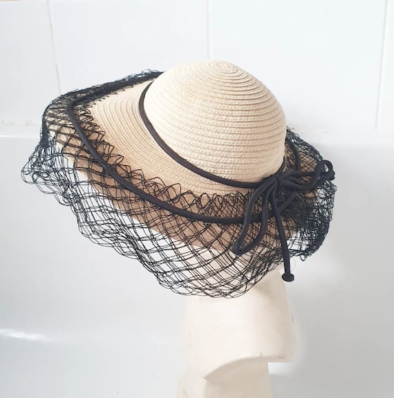 Stylish late 1940s straw hat with black trim and n