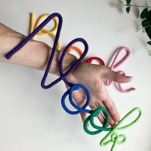 Close-up of colorful rope letters on Book Nook sign, children’s playroom wall decoration