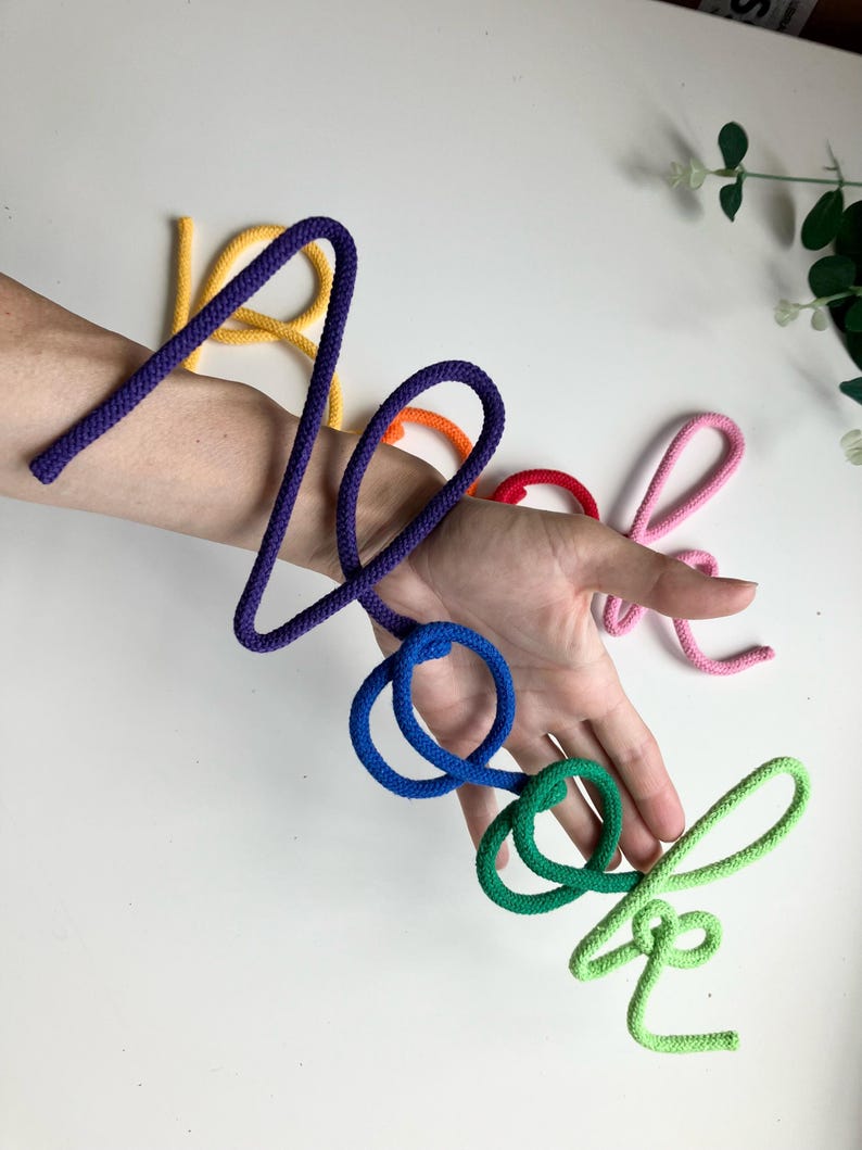 Close-up of colorful rope letters on Book Nook sign, children’s playroom wall decoration