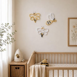 Bee themed nursery decor with handmade rope bees on wall
