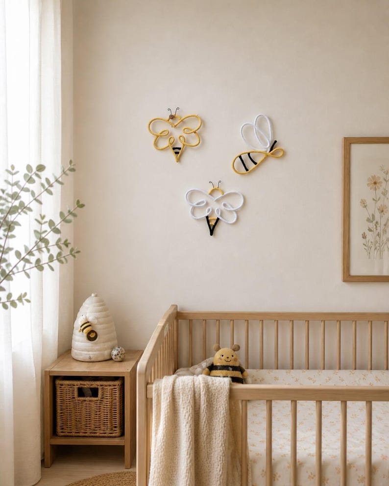 Bee themed nursery decor with handmade rope bees on wall