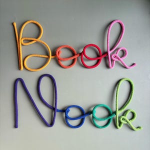 Thick cotton rope and wire construction on rainbow Book Nook sign, handmade nursery decor.