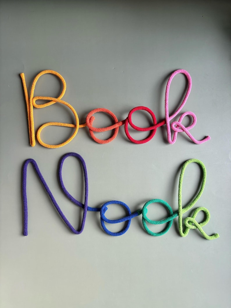 Thick cotton rope and wire construction on rainbow Book Nook sign, handmade nursery decor.