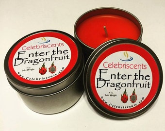 May include: Three round, silver-colored tins with red candles inside. The labels read "Enter the Dragonfruit" with dragonfruit illustrations. The brand name "Celebriscents" is also visible on the labels. Each candle weighs 4 oz.