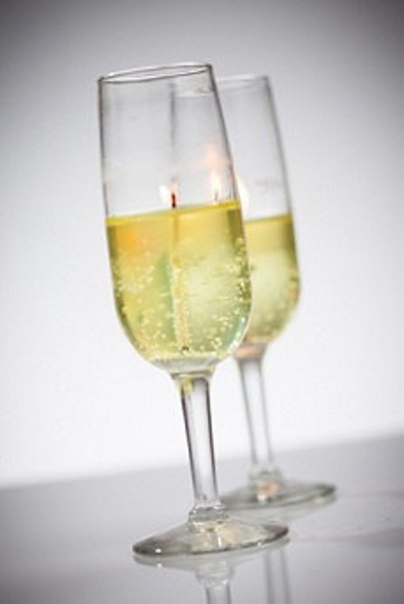 Champagne scented long lasting bubbly gel candles in tall flutes or goblets. Perfect for wedding and festive events.  Comes in pairs.