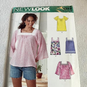 May include: A sewing pattern for tops and blouses. The pattern includes four different styles: a yellow top with flutter sleeves, a floral print top with a square neckline, a purple top with a square neckline, and a pink top with a square neckline. The pattern is for sizes 10-22.