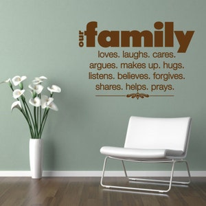 May include: A wall decal with the words "our family" in brown lettering. Below, a list of family values is written. A white vase with white flowers and a white chair are in the image.