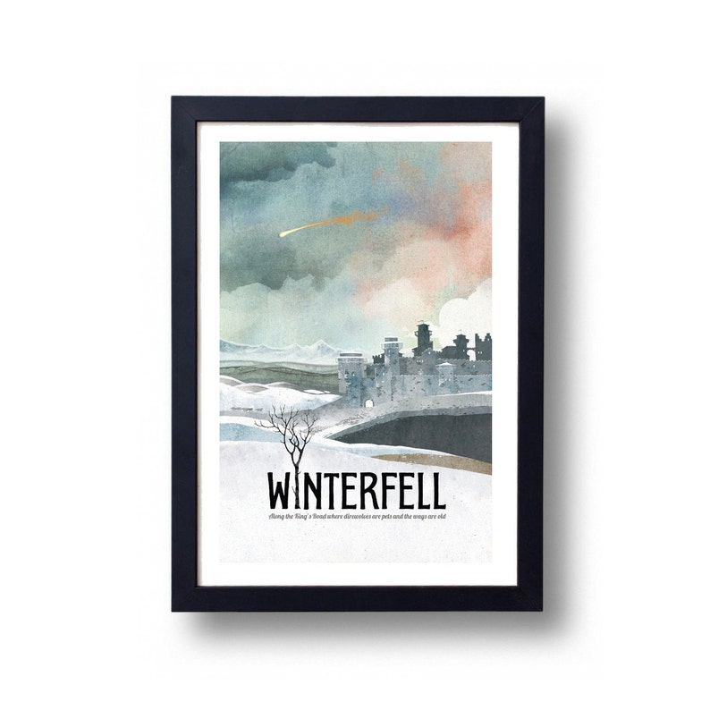 May include: A framed art print featuring a watercolor illustration of Winterfell, with a castle, snowy landscape, and a dramatic sky. The print includes the word "WINTERFELL" and a quote. The frame is black.