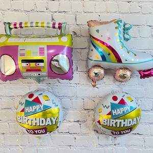 May include: Four colorful foil balloons, two are birthday balloons with the text "Happy Birthday To You" and two are shaped like a boombox and roller skate.