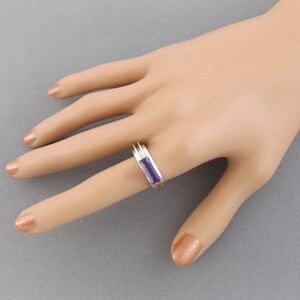 Sterling silver 'abstract' ring with 18k white gold setting and Amethyst baguette gem. Sterling silver 'abstract' ring with 18k white gold setting and Amethyst baguette gem.