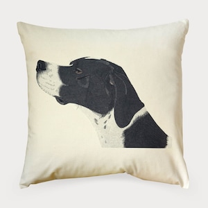 May include: A white pillow with a black and white illustration of a dog's head. The dog is looking to the right and has a black nose and black eyes.