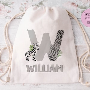 May include: White drawstring bag featuring a black and white zebra print letter W and a small zebra illustration. The bag is personalised with the name "William".