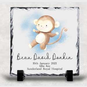 May include: A square slate tile with a watercolor illustration of a brown monkey against a blue background. The tile includes the name "Beau David Donkin" and birth details: 10th January 2021, 6lbs 4oz, and Sunderland Royal Hospital.