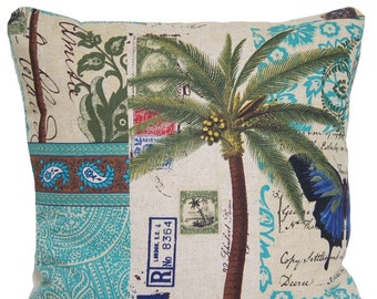 May include: Square cushion with a tropical design. It features a palm tree, stamps, and a blue butterfly on a beige backdrop. Teal paisley patterns and script writing add detail. The cushion is square in shape.