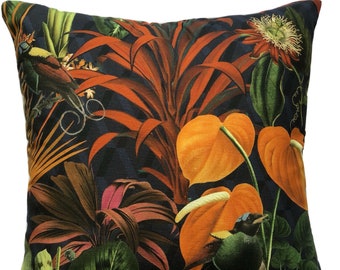 May include: A dark blue throw pillow with a tropical print featuring orange and green birds, orange and green leaves, and a red flower.
