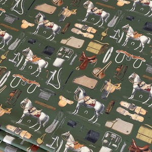 May include: A green fabric with a repeating pattern of horses, saddles, and equestrian equipment. The pattern is in shades of brown, black, and white.