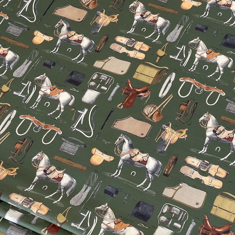 May include: A green fabric with a repeating pattern of horses, saddles, and equestrian equipment. The pattern is in shades of brown, black, and white.