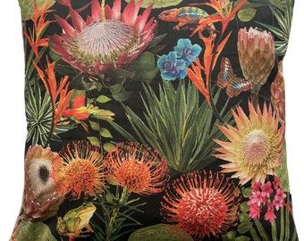 May include: A black and green throw pillow with a colorful floral print featuring proteas, orchids, butterflies, and frogs. The pillow has a square shape and a soft, textured fabric.