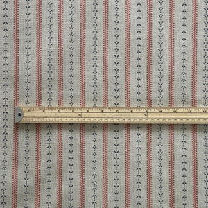 The design combines blush-red bands with delicate navy leaf dots for a subtle, timeless look.