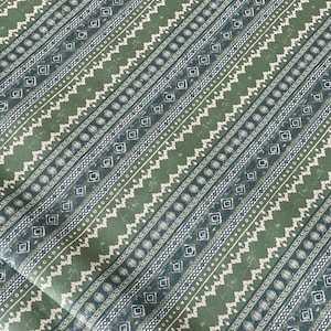 “Green and cream woven-look cotton fabric with rustic folk-inspired stripes and geometric accents – ideal for handmade curtains, cushions, and artisan home decor.