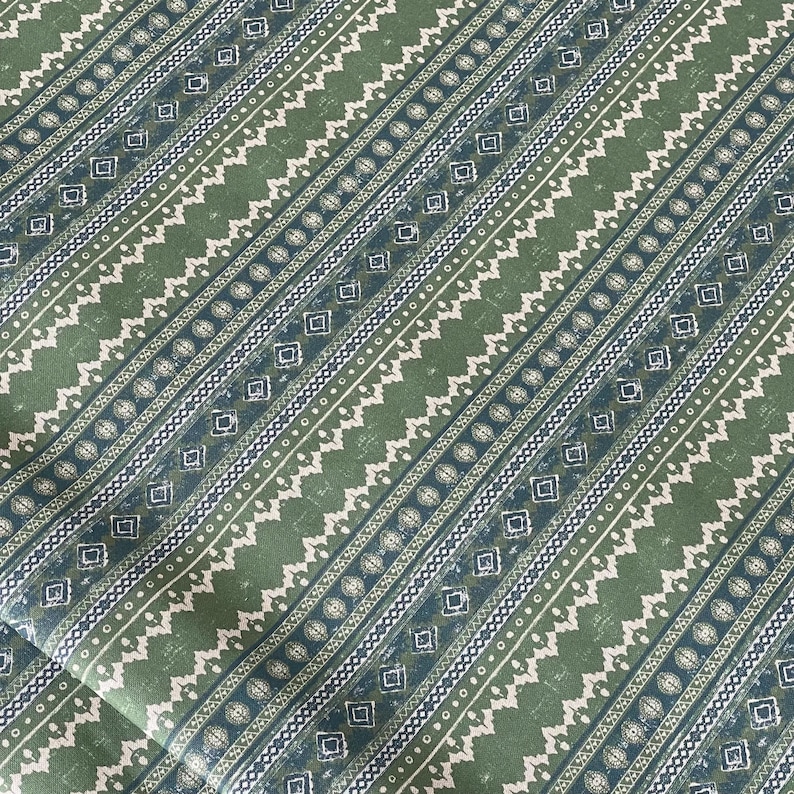 “Green and cream woven-look cotton fabric with rustic folk-inspired stripes and geometric accents – ideal for handmade curtains, cushions, and artisan home decor.