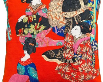 May include: Red throw pillow with a colorful Japanese-inspired design featuring three women in traditional clothing and floral patterns.