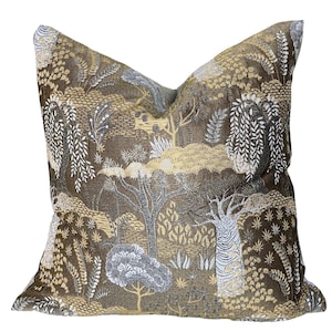 May include: A brown throw pillow with a gold and white patterned design featuring trees and foliage.