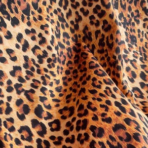 Designer leopard velvet fabric with rich brown, caramel and black spots sold by the metre.
