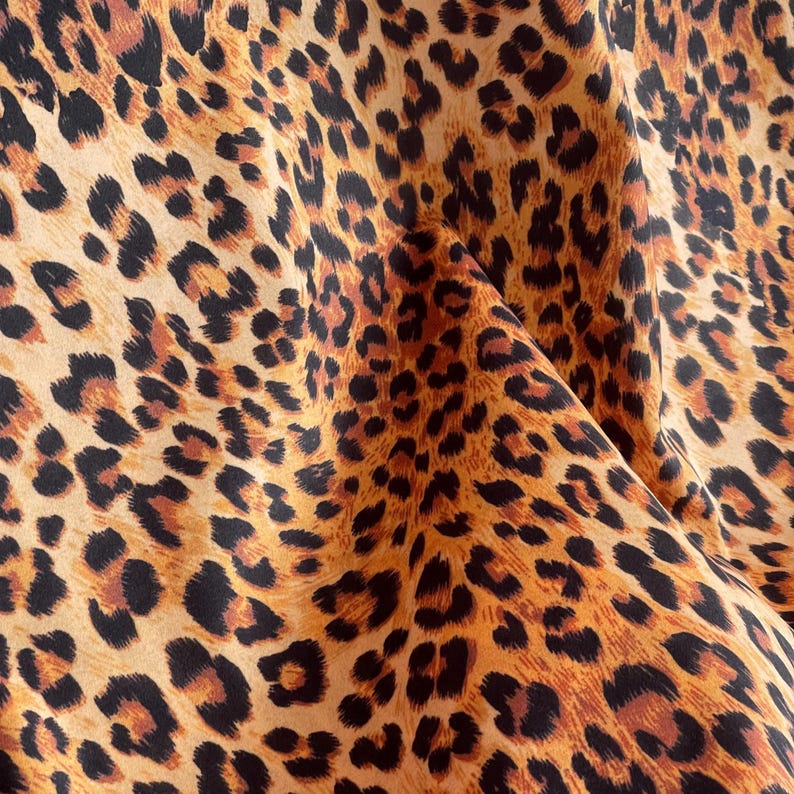 Designer leopard velvet fabric with rich brown, caramel and black spots sold by the metre.