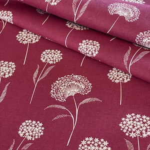 May include: Red fabric with a white floral pattern. The fabric features a repeating design of white flowers with a small, round centre and multiple petals.