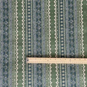 Rustic sage and indigo stripe cotton fabric with ruler for scale – ideal for cottagecore curtains, handmade cushions, and artisan sewing projects.