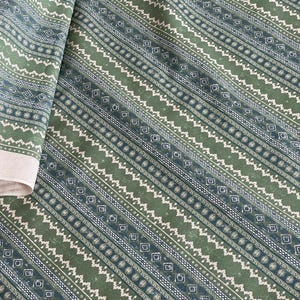 Textured sage green cotton fabric with tribal-style lines and diamonds – ideal for eco-conscious home decor, drapes, cushions, or boho-inspired sewing