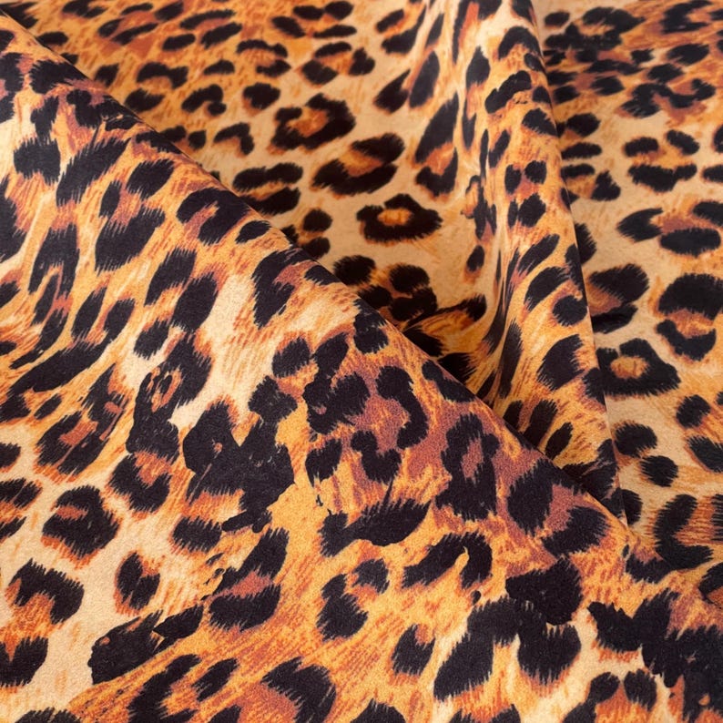 Luxury leopard print Italian velvet fabric in golden tan and black tones suitable for upholstery, curtains and cushions.