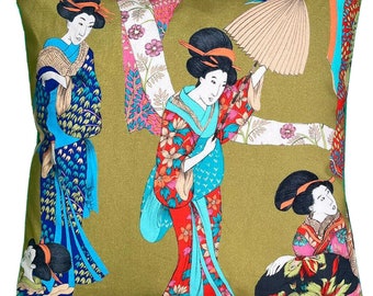May include: A green throw pillow with a colorful print of three women in traditional Japanese clothing. The women are wearing vibrant red, blue, and pink kimonos with floral patterns. The background is a muted green with a floral design.