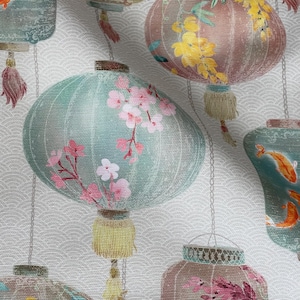 May include: A fabric design showing multiple hanging paper lanterns in teal, pink, and brown. The lanterns are adorned with floral patterns and tassels, set against a white backdrop with a subtle wave design. The theme is Asian-inspired, with measurements in cm.