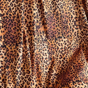 Premium Italian velvet fabric showcasing classic leopard print for statement interiors and soft furnishings.