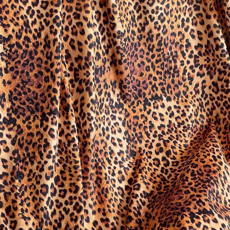 Premium Italian velvet fabric showcasing classic leopard print for statement interiors and soft furnishings.