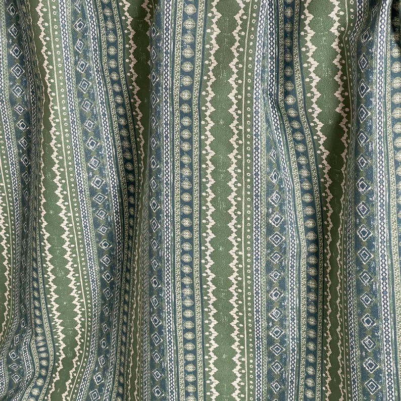 Folk-style cotton fabric with sage green and denim blue stripes, shown with scale – perfect for boho curtains, cushion covers, and handmade home projects